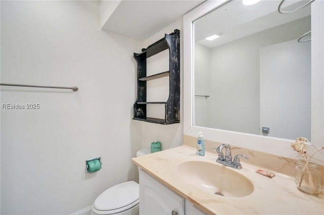 bathroom featuring vanity and toilet