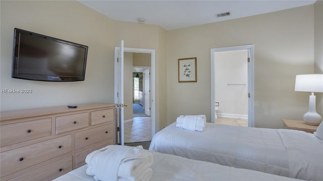 bedroom with tile patterned flooring and ensuite bath