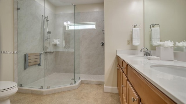 bathroom with vanity, radiator, toilet, and a shower with shower door