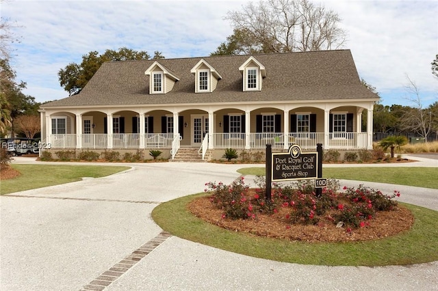 cape cod home featuring covered porch and a front yard