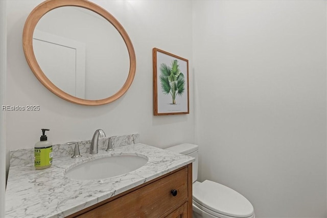 bathroom featuring vanity and toilet