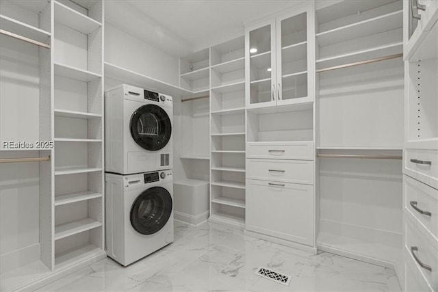 washroom featuring stacked washer / dryer