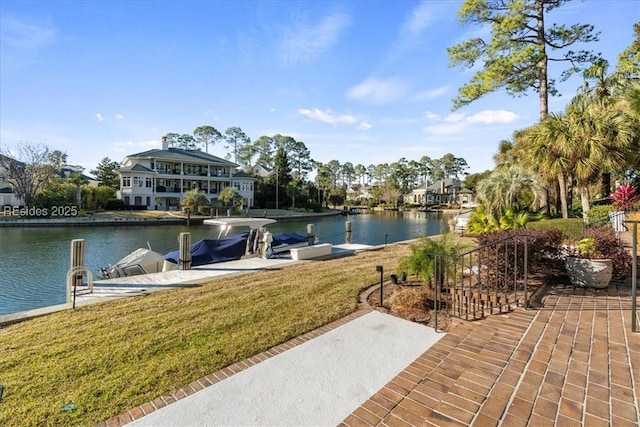 dock area featuring a water view and a lawn