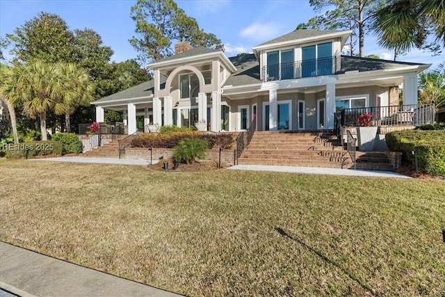 view of front of home featuring covered porch and a front lawn