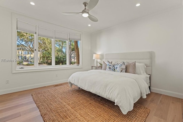 bedroom featuring light hardwood / wood-style floors and ceiling fan