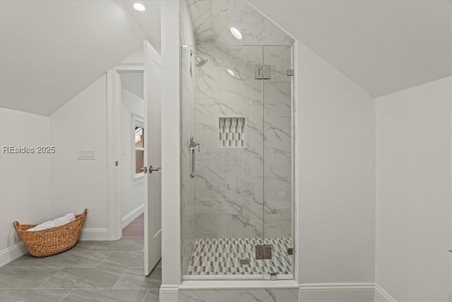 bathroom with lofted ceiling and a shower with shower door