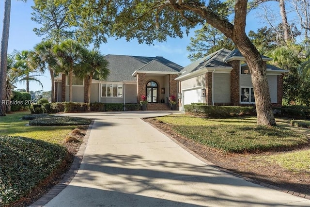 ranch-style home featuring a garage and a front yard