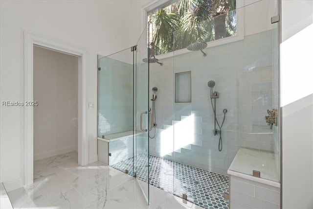 bathroom with a shower with door