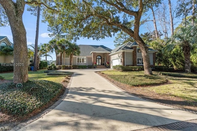 ranch-style home featuring a garage and a front lawn