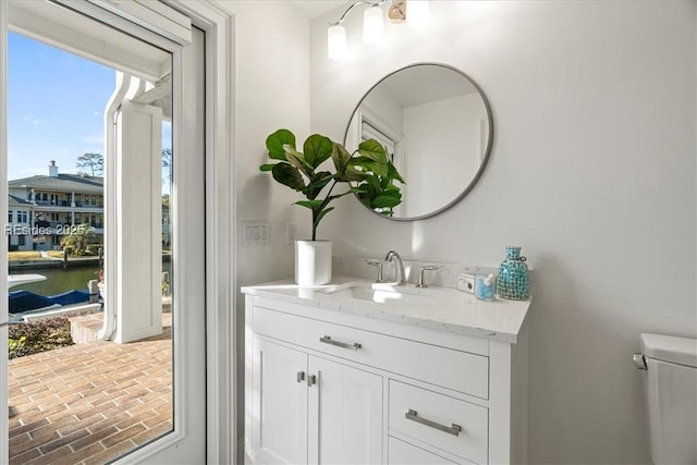 bathroom featuring vanity, a water view, and toilet