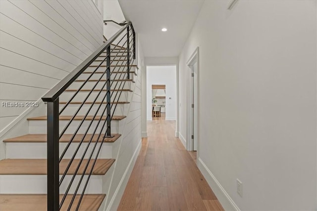 hallway with hardwood / wood-style flooring