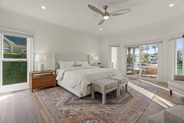 bedroom featuring access to exterior, crown molding, hardwood / wood-style floors, and ceiling fan