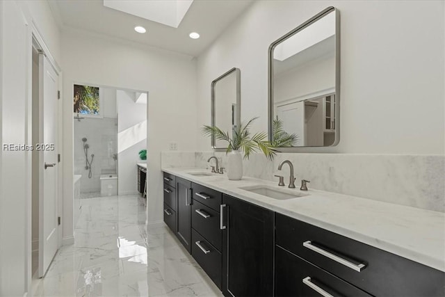 bathroom with vanity, a skylight, and a shower