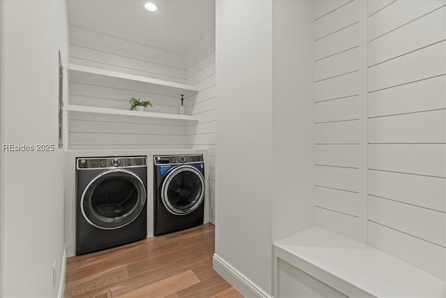 laundry room with light hardwood / wood-style flooring and independent washer and dryer