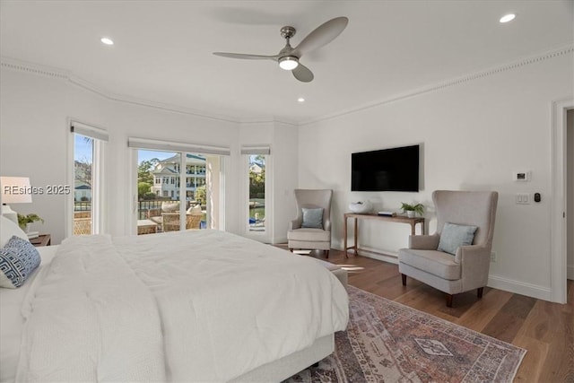 bedroom featuring hardwood / wood-style floors, access to outside, ceiling fan, and multiple windows