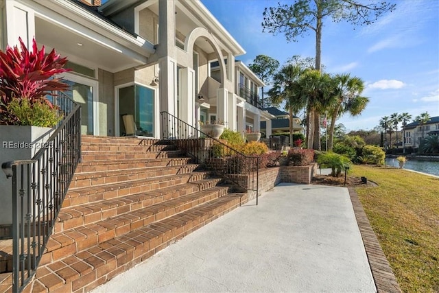 exterior space featuring a water view and a yard