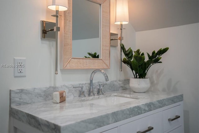 bathroom with vanity and vaulted ceiling