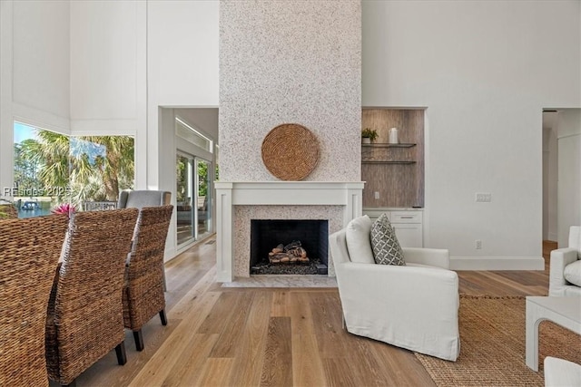 living room with a high ceiling and light wood-type flooring