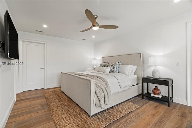 bedroom with ceiling fan and hardwood / wood-style floors