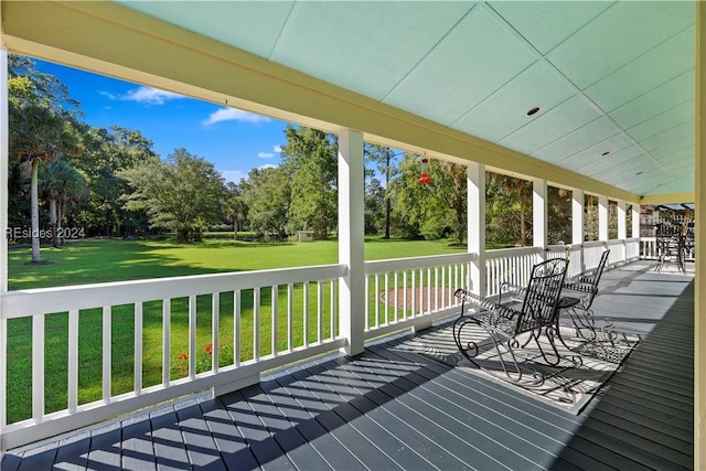 wooden deck featuring a yard