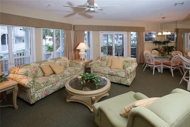 living room featuring ceiling fan with notable chandelier and carpet floors