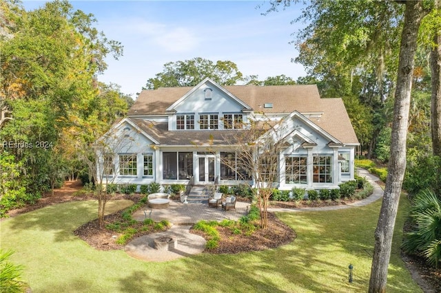 back of house with a yard, a sunroom, and a patio