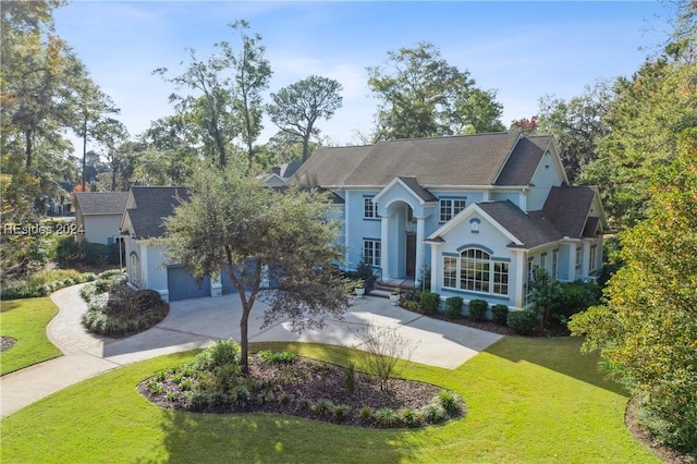 view of front facade with a garage and a front yard