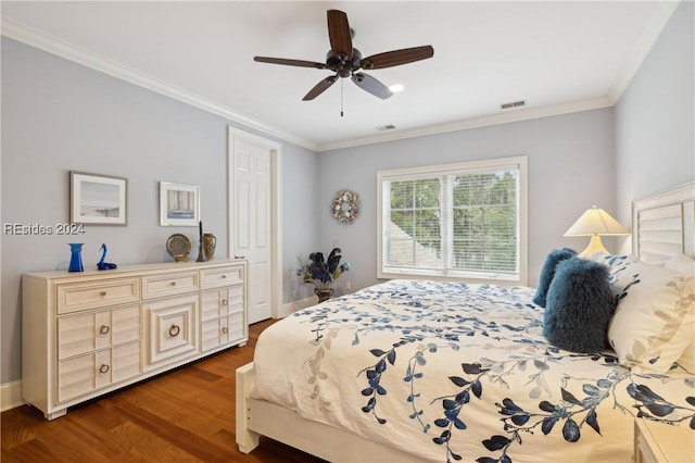 bedroom featuring dark hardwood / wood-style flooring, ornamental molding, and ceiling fan