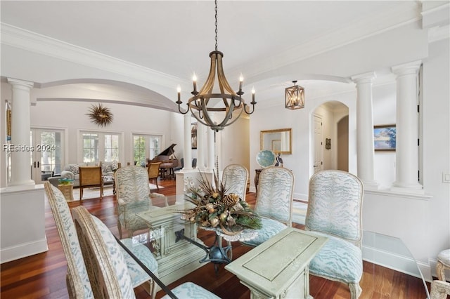 dining space with crown molding, dark wood-type flooring, and ornate columns