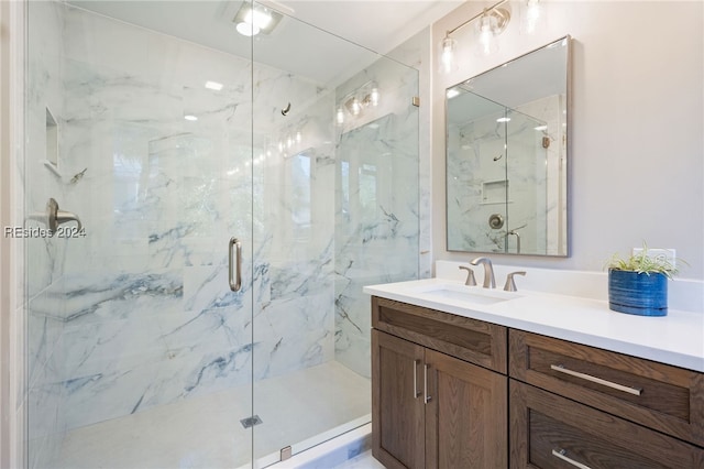 bathroom featuring vanity and an enclosed shower