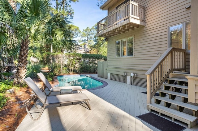 view of swimming pool with a deck