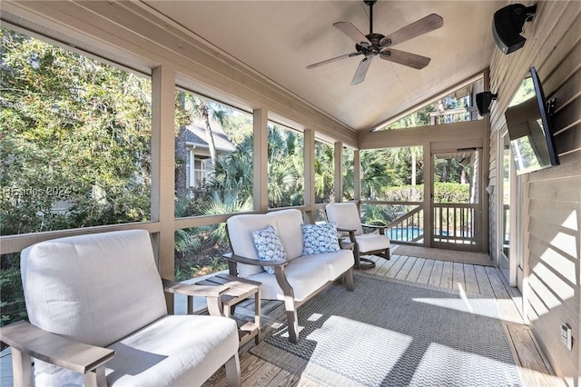 sunroom / solarium featuring lofted ceiling and ceiling fan