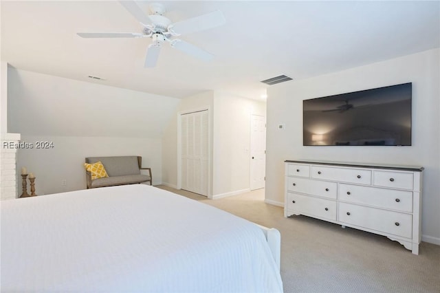 unfurnished bedroom featuring vaulted ceiling, light carpet, and ceiling fan