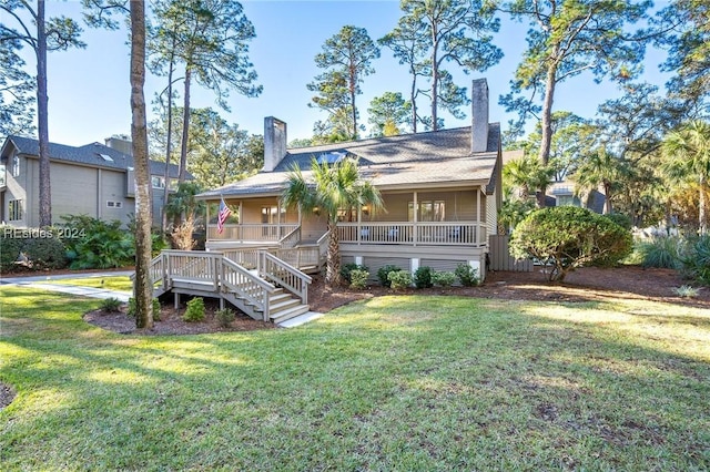 view of front facade with a front yard and covered porch