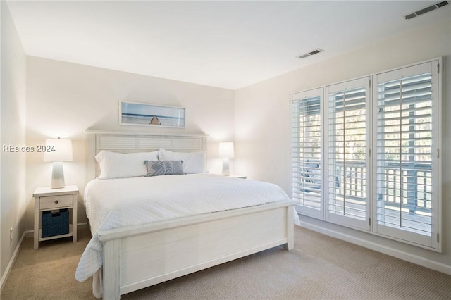 bedroom featuring light carpet