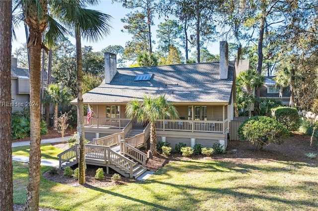 back of house with a porch and a yard