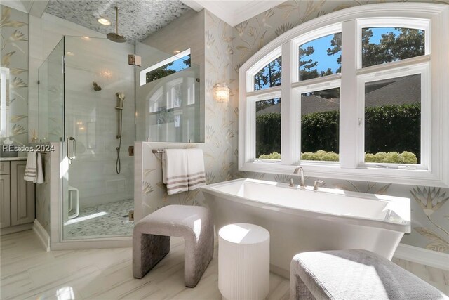 bathroom featuring shower with separate bathtub