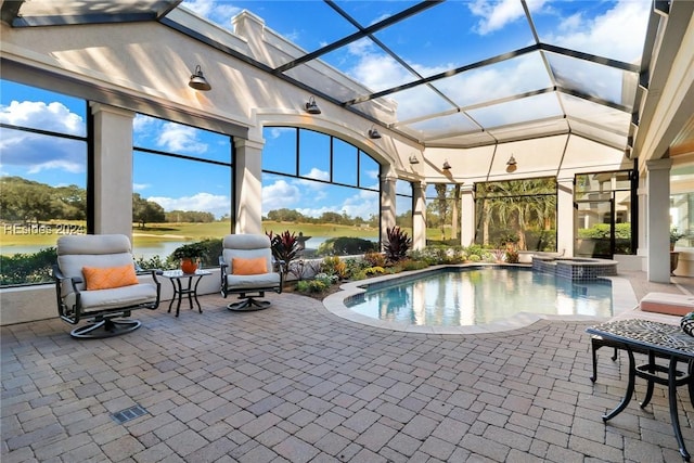 view of swimming pool with a lanai, an in ground hot tub, a patio, and a water view