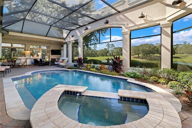 view of swimming pool with an in ground hot tub, an outdoor kitchen, and a patio area