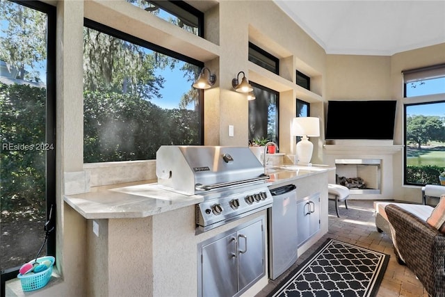 view of patio / terrace with an outdoor kitchen, a grill, and a fireplace