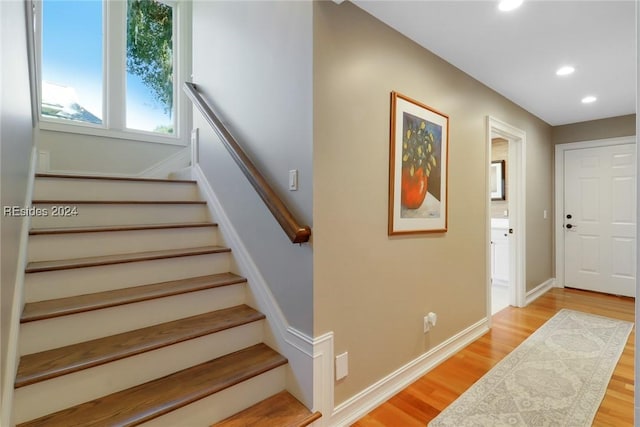 stairway with hardwood / wood-style flooring