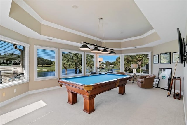 rec room with a tray ceiling, plenty of natural light, and light colored carpet