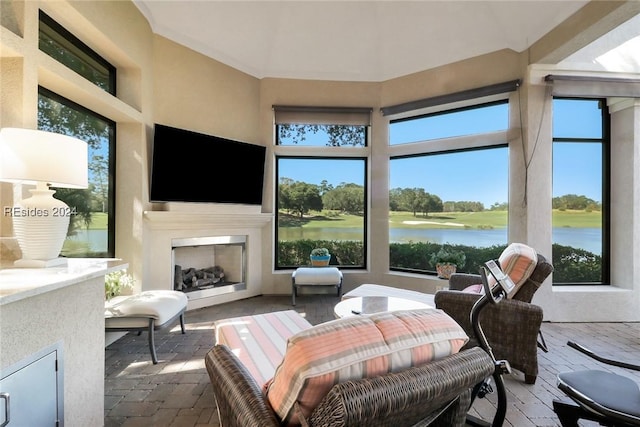 sunroom / solarium with exterior fireplace and a wealth of natural light