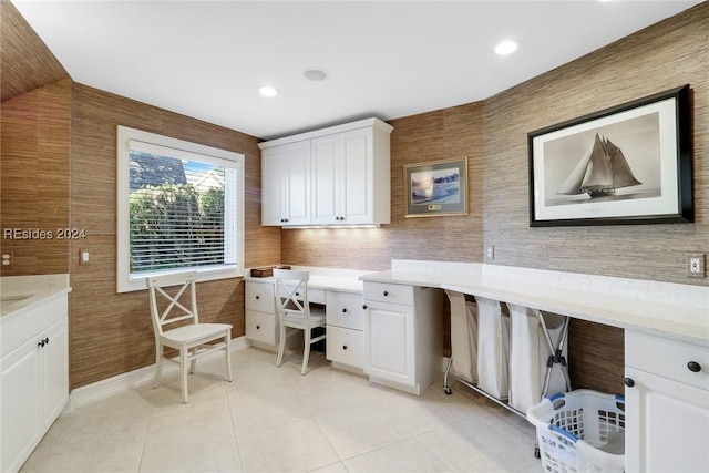 office space featuring built in desk and light tile patterned floors