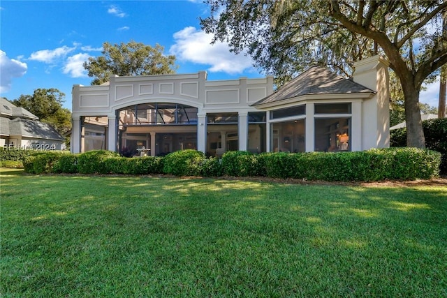 rear view of house with a lawn