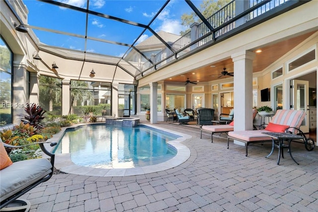 view of pool featuring ceiling fan, a lanai, and a patio area