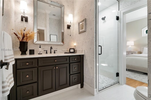 bathroom featuring a shower with door, vanity, and toilet