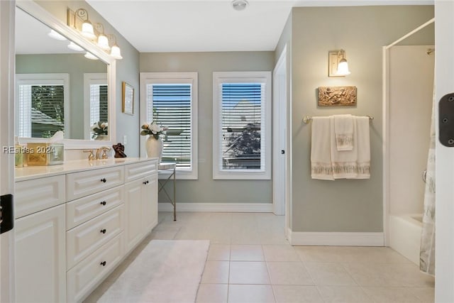 bathroom with tile patterned flooring, vanity, a healthy amount of sunlight, and shower / tub combination