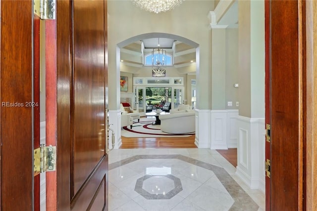 tiled entrance foyer with a notable chandelier