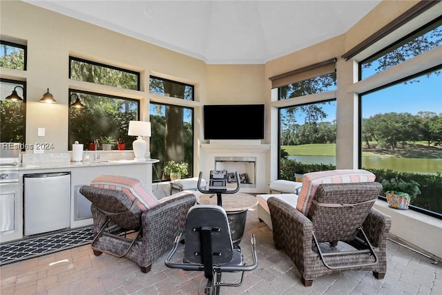 sunroom / solarium featuring an outdoor fireplace